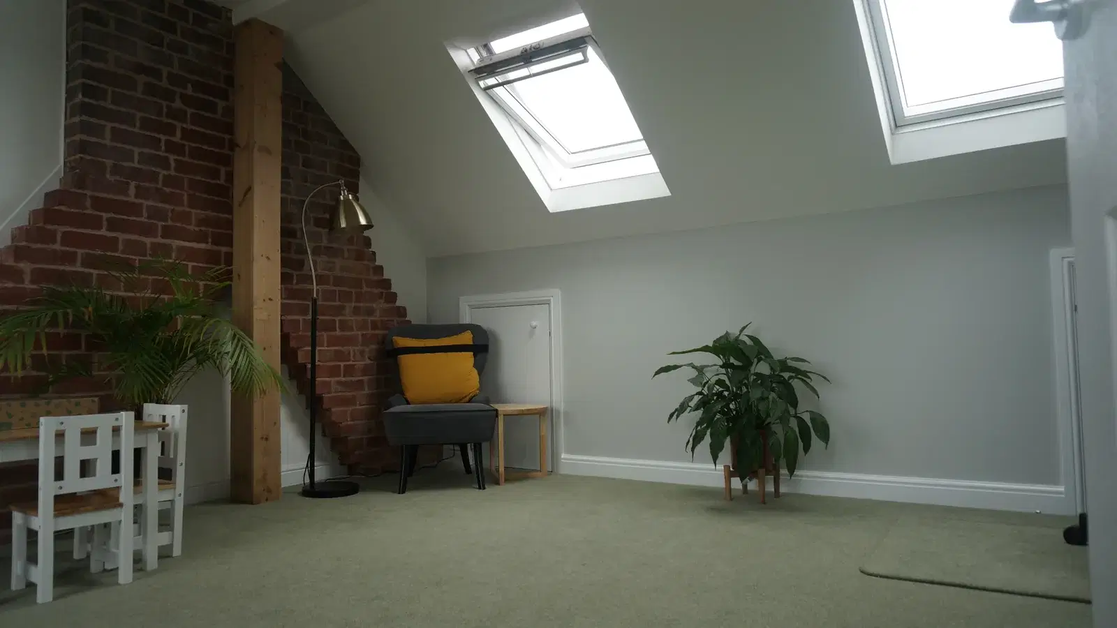 Loft conversions: finished loft room with sloping ceiling and rooflights